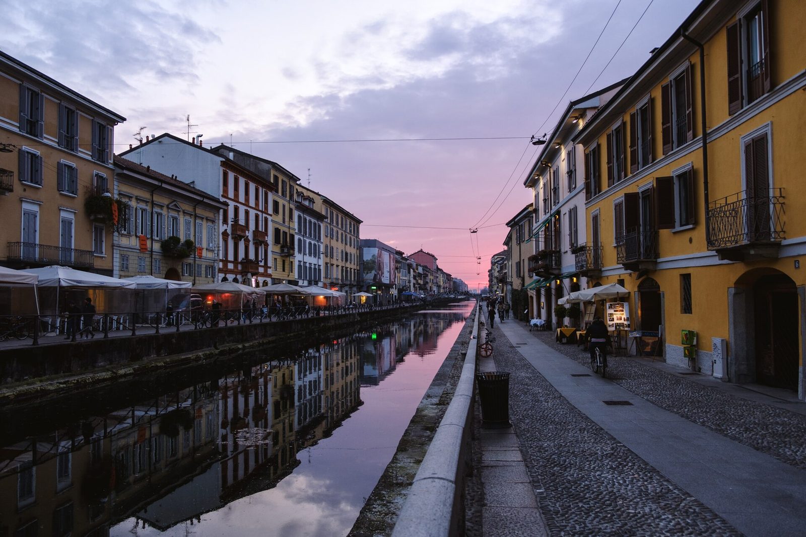 The Navigli canals glowing at dusk, Milan's aperitivo heartland.