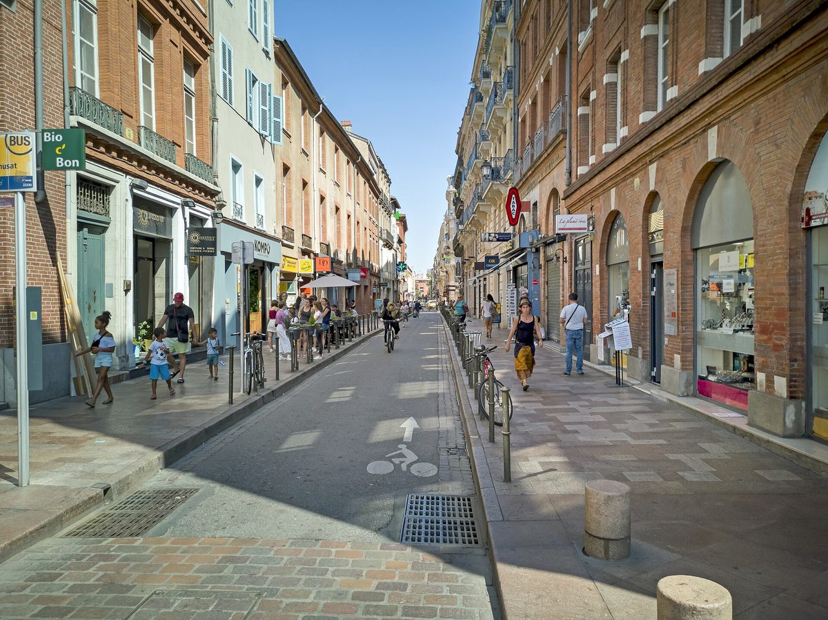 A brick-lined shopping street near Place du Capitole.