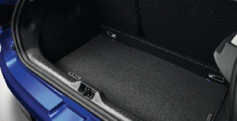 Open boot of the Renault Captur loaded with a travel bag and a rolled mat, rear seats up